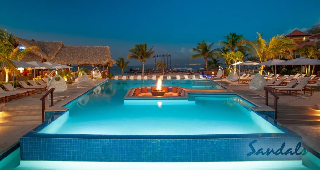 A beautiful firepit in the middle of the pool with a great ocean view of one of the best Sandals Resort - "Sandals Grenada"